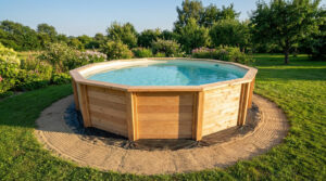 A beautiful above-ground wooden pool with crystal clear water in a sunny, lush garden, set on a sand and geotextile base.